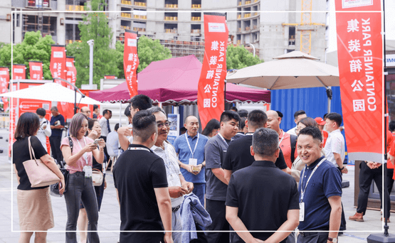 People networking at Intermodal Asia in front of branded banners